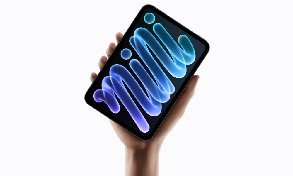 Hand holding up Apple iPad mini (A20 Pro)
