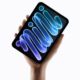 Hand holding up Apple iPad mini (A20 Pro)