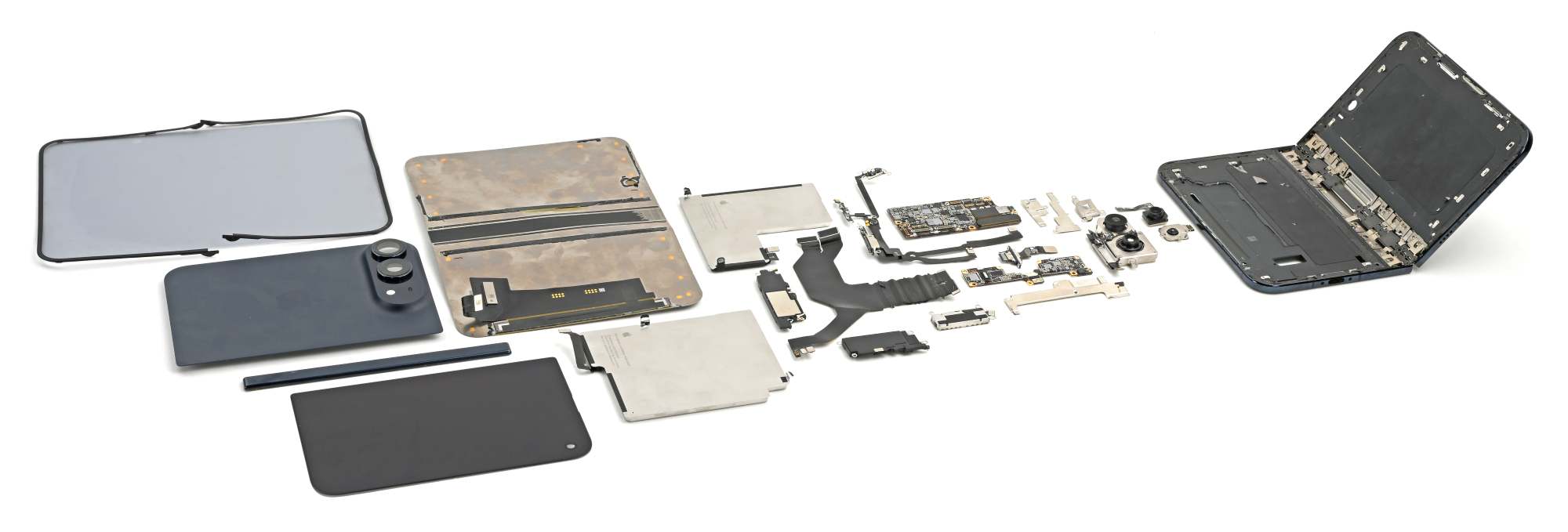 iFixit teardown of the Apple iPhone Duo showing its internal components, dual batteries, hinge assembly, and unstacked logic board laid out flat.